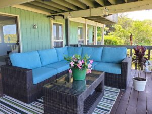 The Sectional 6 Piece with brown rattan and aqua blue cushions transforms the outdoor space.